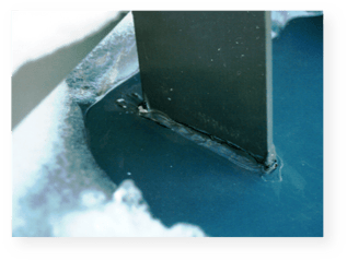 Example of a waterproofing failure in a mechanically-attached (non-penetrating) snow guard system