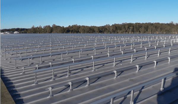 S-5!® - Rail-mounted solar panel installation on a commercial facility – using ≈ 9,000 standing seam clamps – no holes (penetrations) needed in metal roof-min