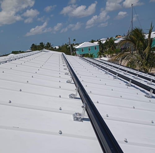 SolarFoot on metal roof profile with bracket attached in the valley