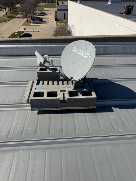 satellite dish mounted with unstable concrete blocks